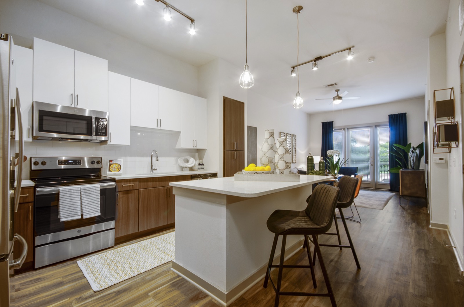 Apartments in Garland for Rent- Spacious Kitchen With Island, Wood Cabinets White Quartz Countertops, and Stainless Steel Appliances