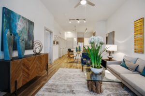 Garland TX Apartments- Spacious Living Room With Tall Ceilings, Stylish Lighting Features, and Ceiling Fan