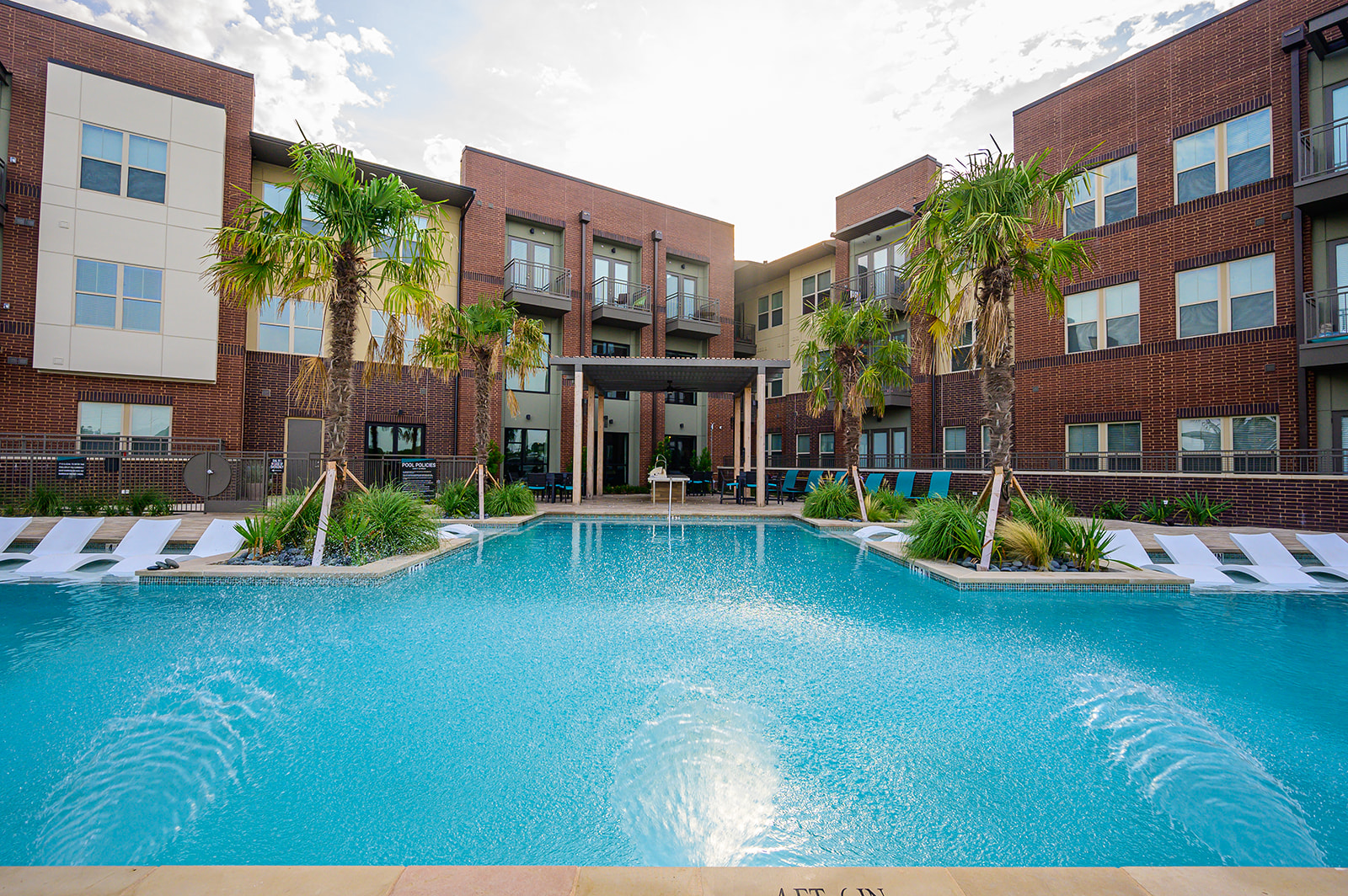 Pool with deck seating and adjacent grilling station